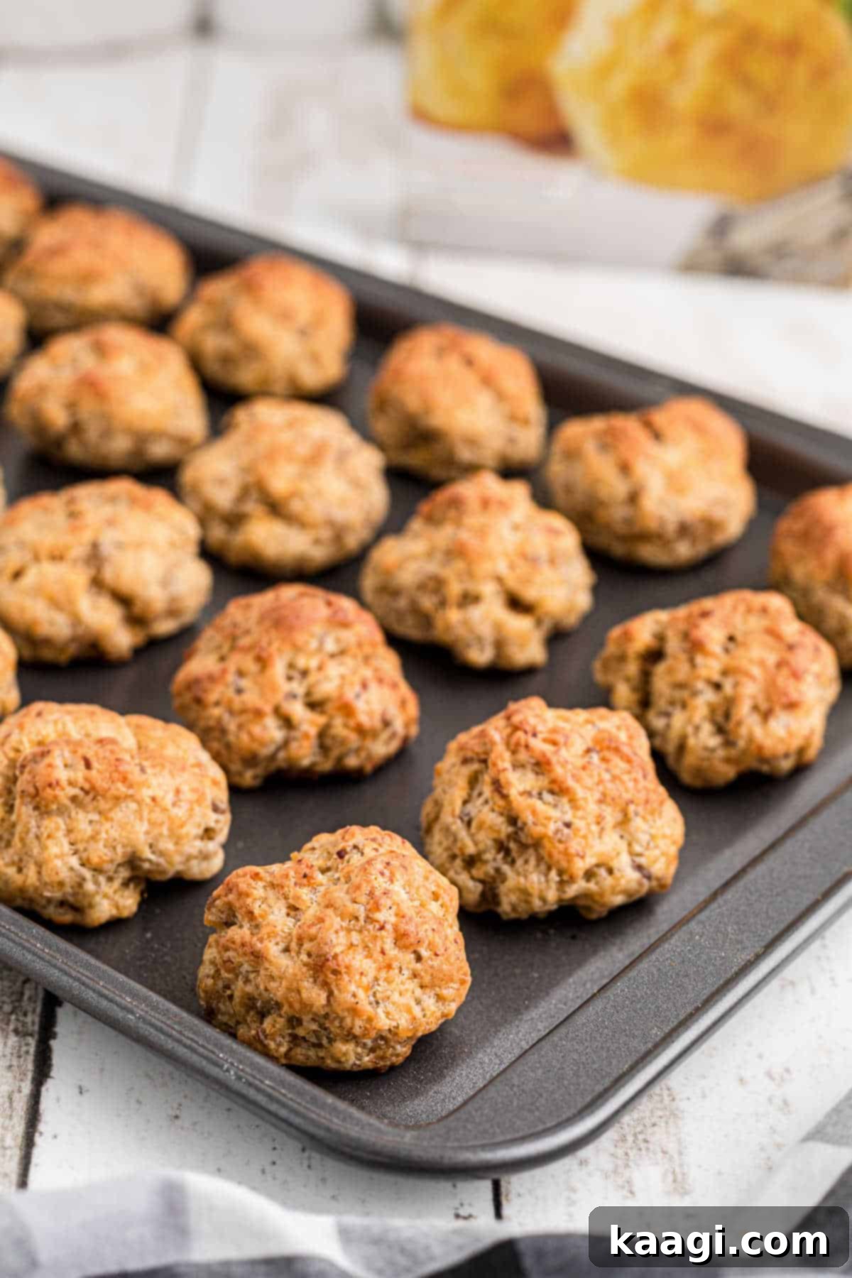 Cheddar Bay Sausage Bites 6 Side shot of a baking sheet with a fresh batch of cheddar bay sausage balls, hot from the oven.