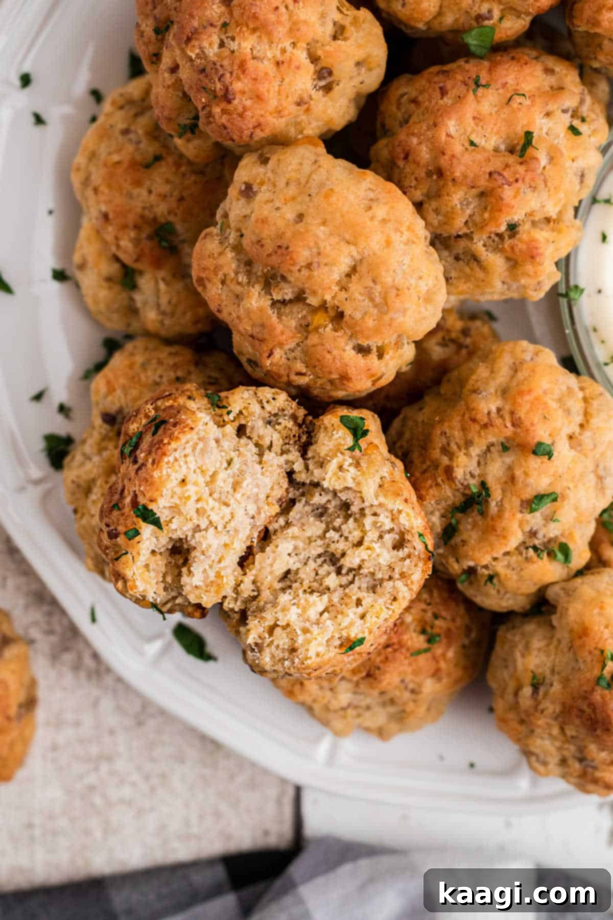 Cheddar Bay Sausage Bites 7 Overhead view of a cheddar bay sausage ball pulled open, revealing its cheesy, savory interior.
