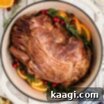 Overhead shot of a Dutch Oven Ham, cropped square, with a rich maple mustard glaze.