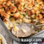 A cropped square image of Amish turkey stuffing recipe, with a spoon resting.