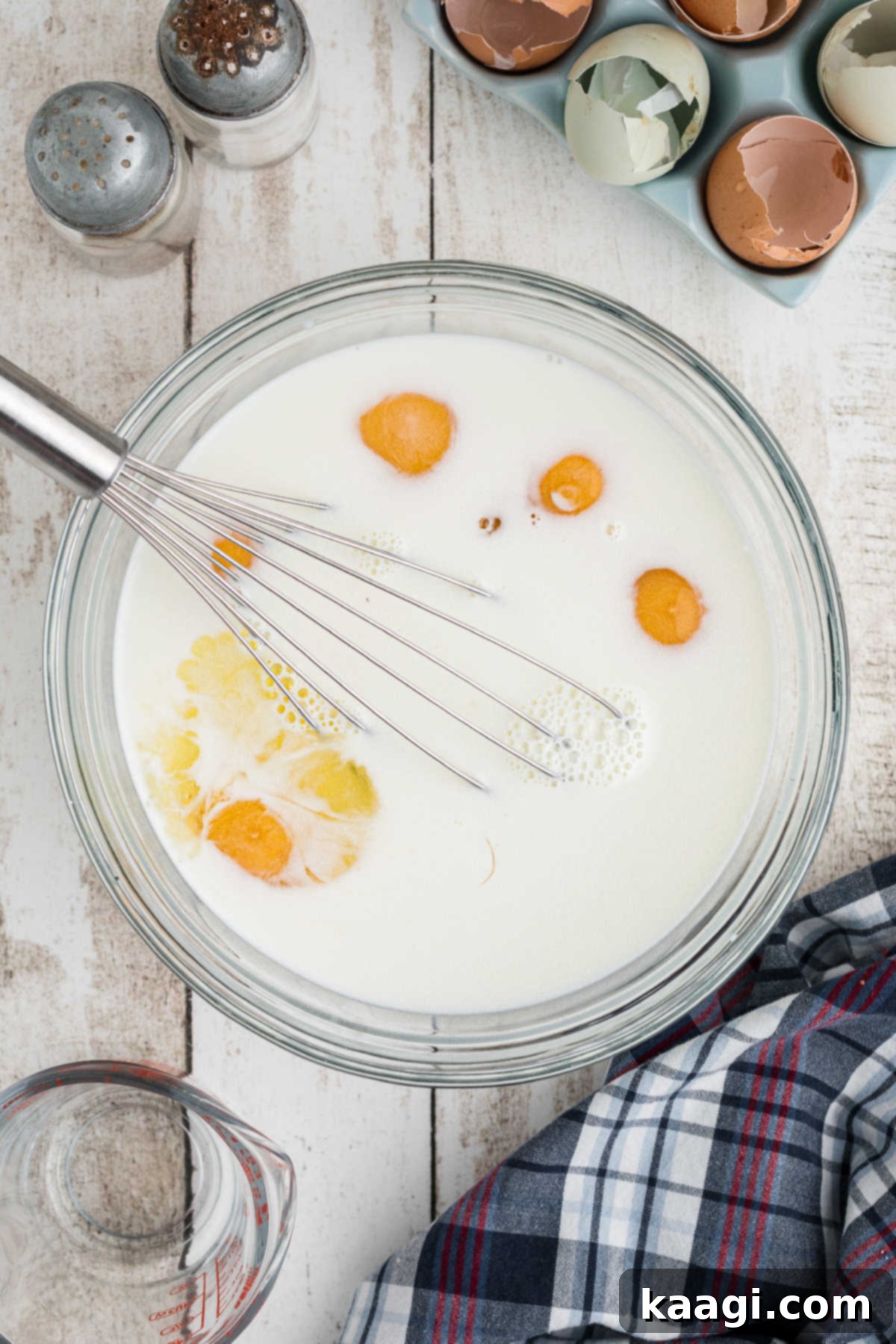 Eggs and milk being beaten together in a bowl.
