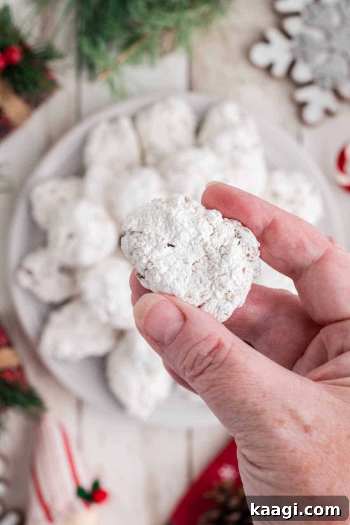 Divine Pecan Clouds 6 Overhead view of a plate of divinity candy being held in hand.