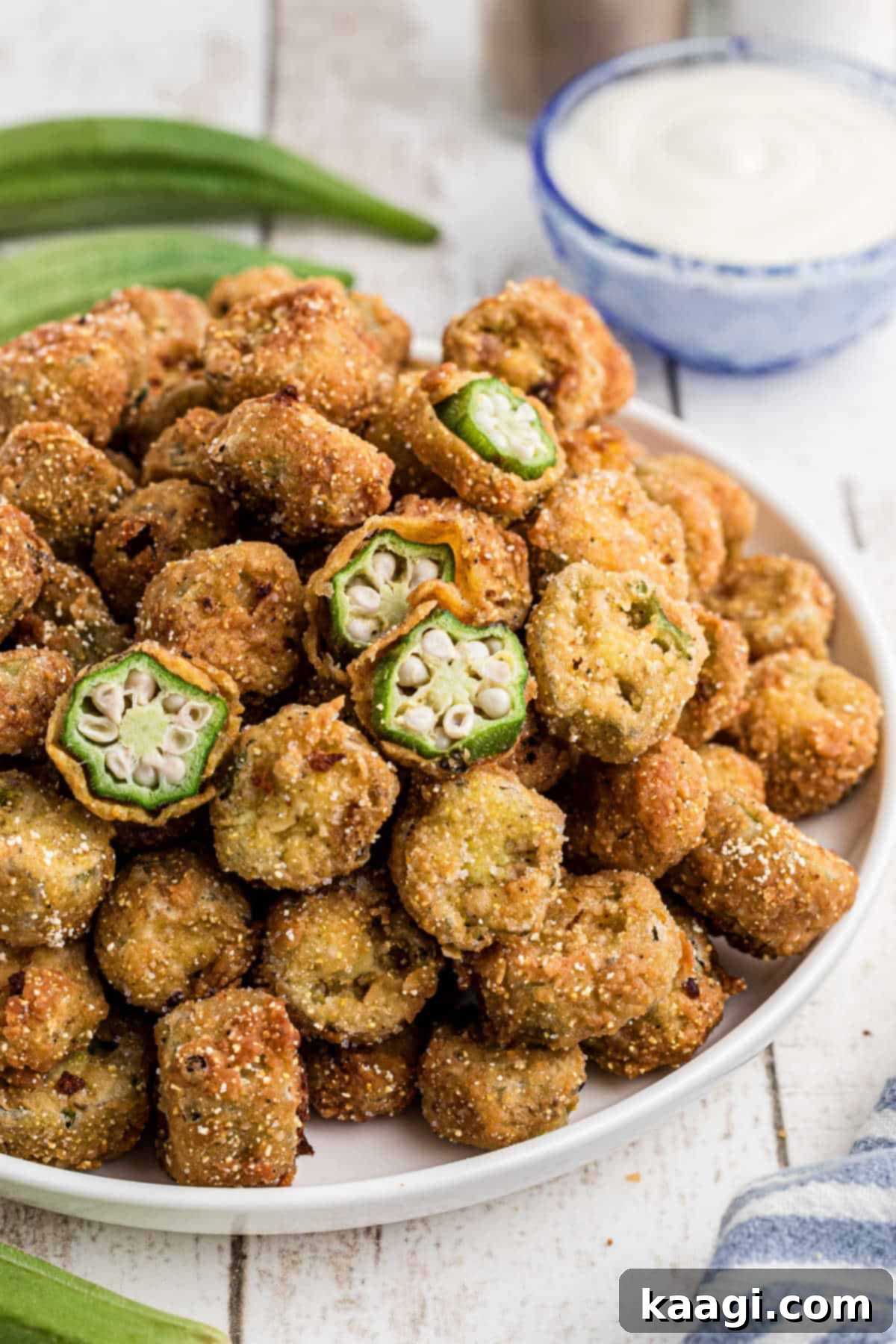Side angled view of a dish full of old fashioned pan fried okra.