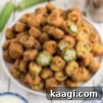 An image of a plate full of old fashioned pan fried okra with one or two cut in half to see the inside.