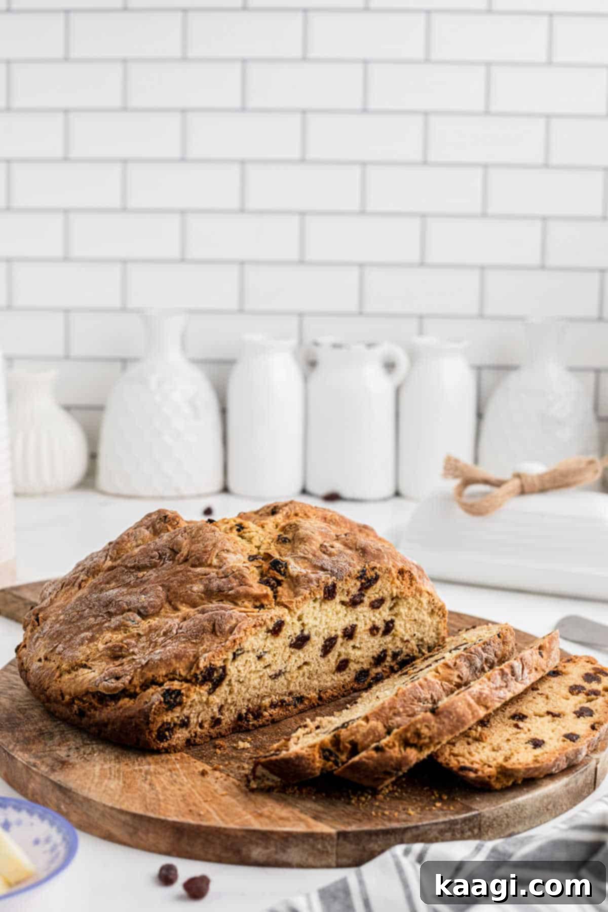 Easy Homemade Irish Soda Bread 12 Side shot of a quick Irish soda bread that has just been sliced, showing its tender crumb and raisins.