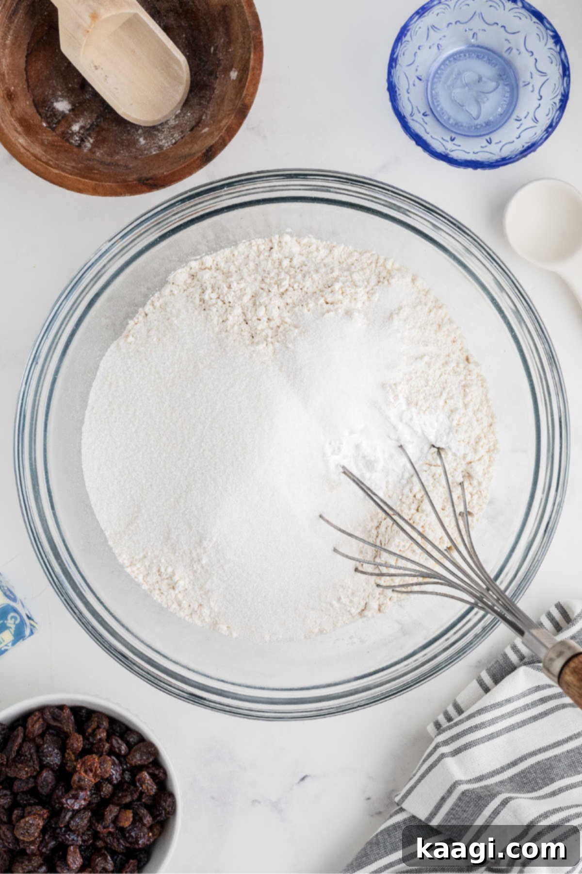 Easy Homemade Irish Soda Bread 4 A large bowl with flour and baking soda, being stirred with a whisk.