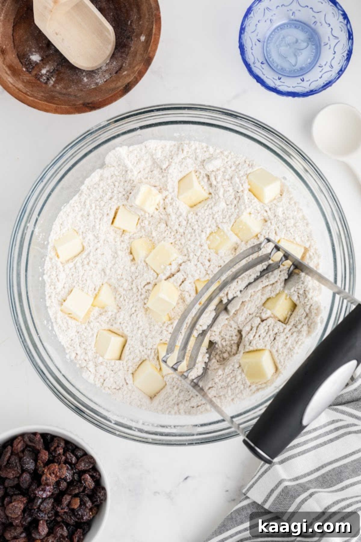 Easy Homemade Irish Soda Bread 5 Cold butter being cut into a bowl of flour using a pastry cutter.
