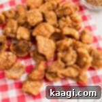 A pile of pork cracklins on a red napkin.