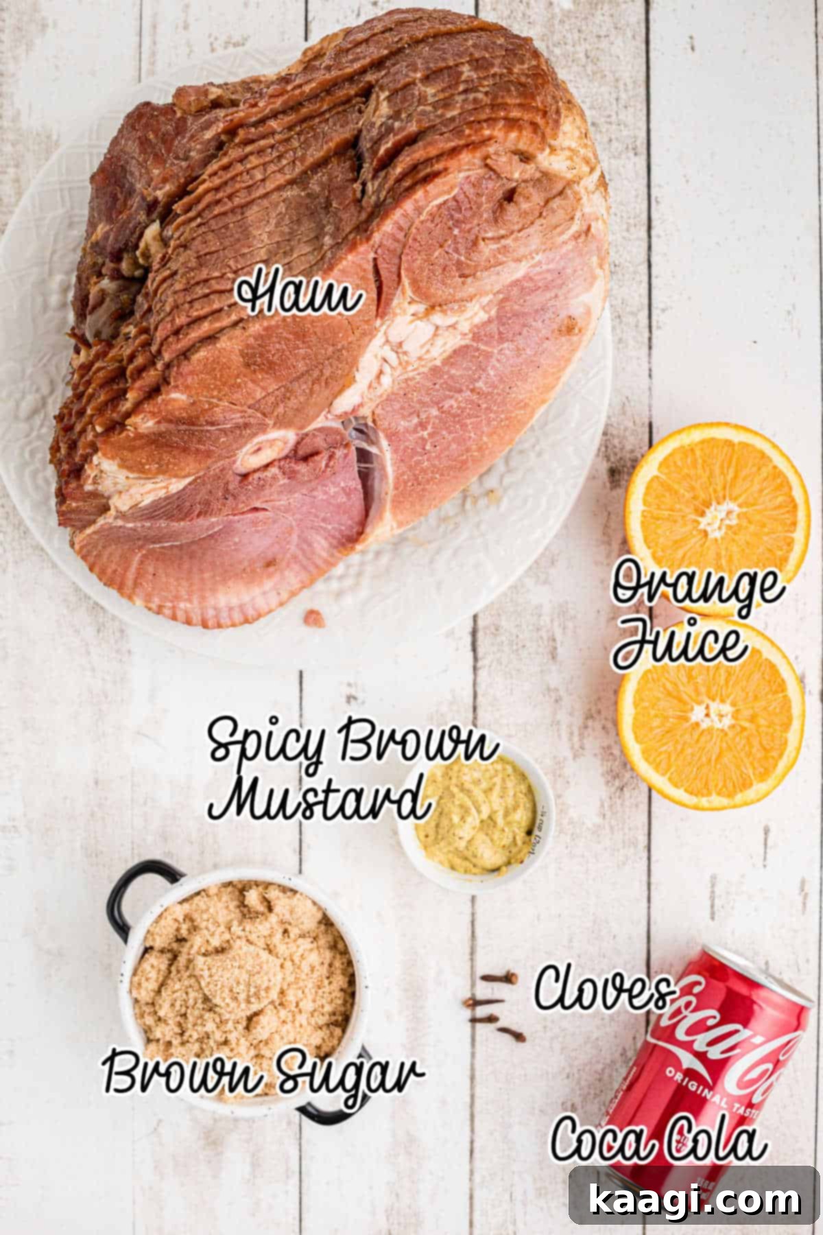 Overhead image of ingredients needed to make a southern coca-cola ham recipe including Coca-Cola, brown sugar, orange juice, mustard, and cloves.