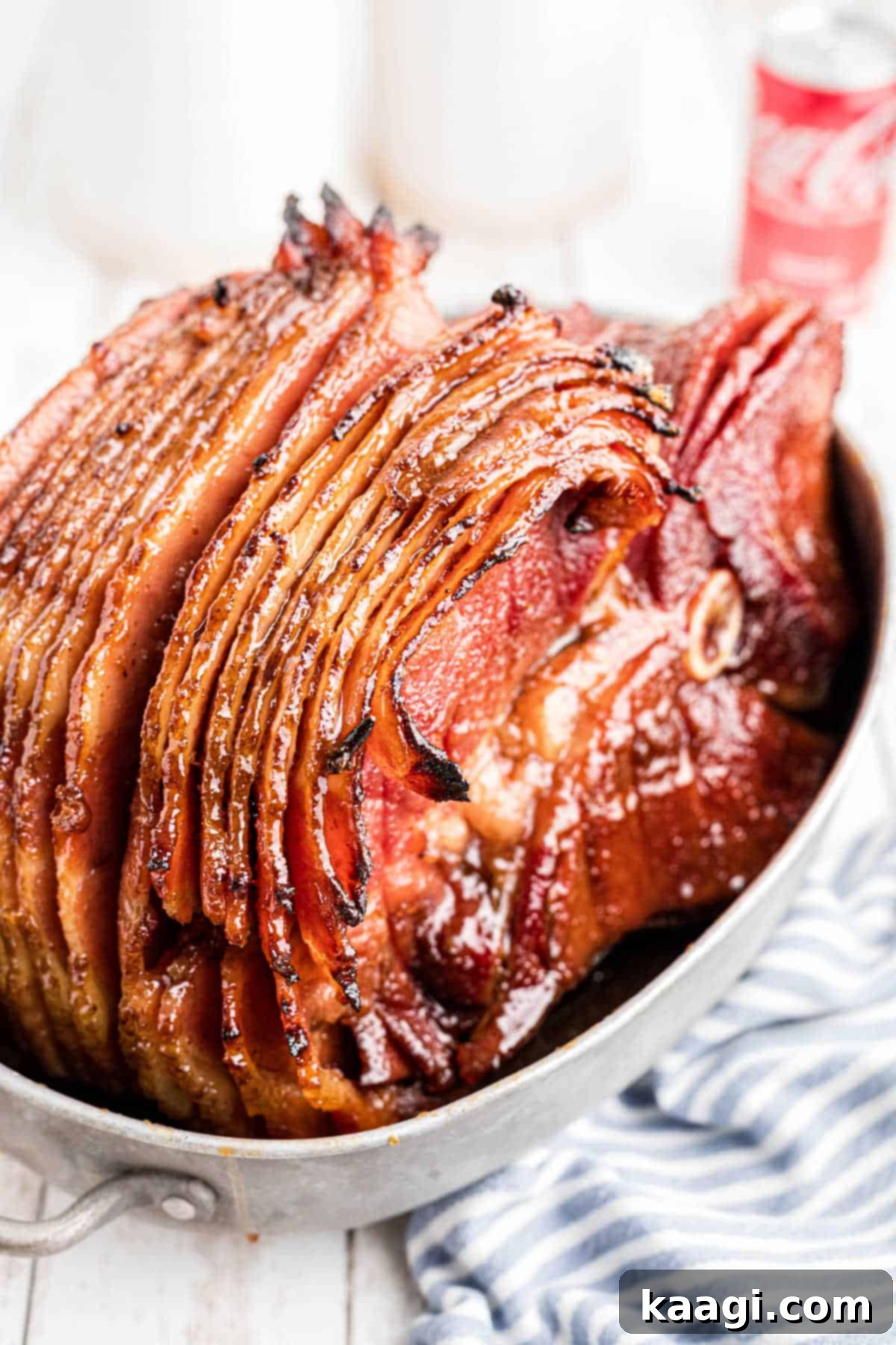 Shot of a baking dish with a southern coca-cola ham cooked inside and beautifully sliced, ready to be served.