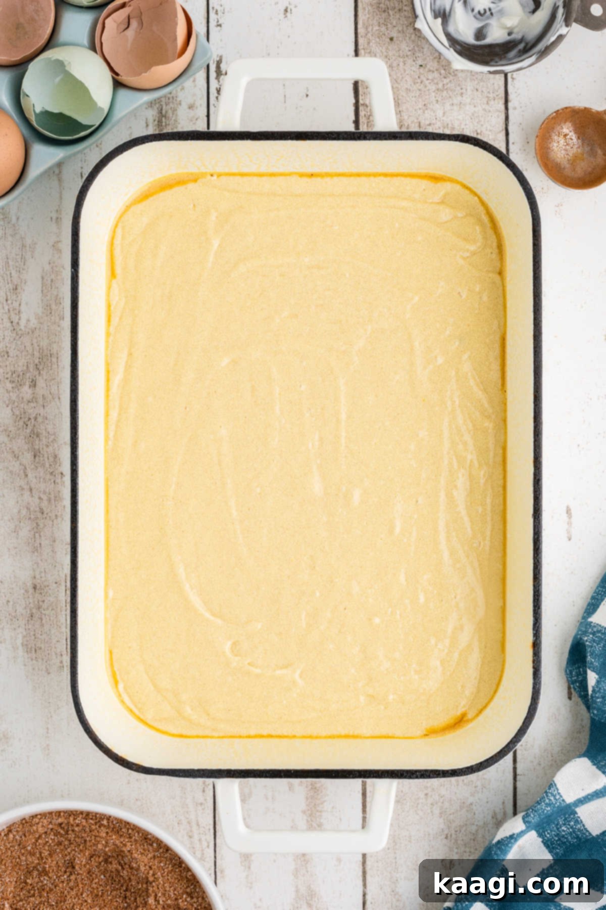 Half of the prepared cake batter spread evenly in a greased 9x13 inch baking dish.