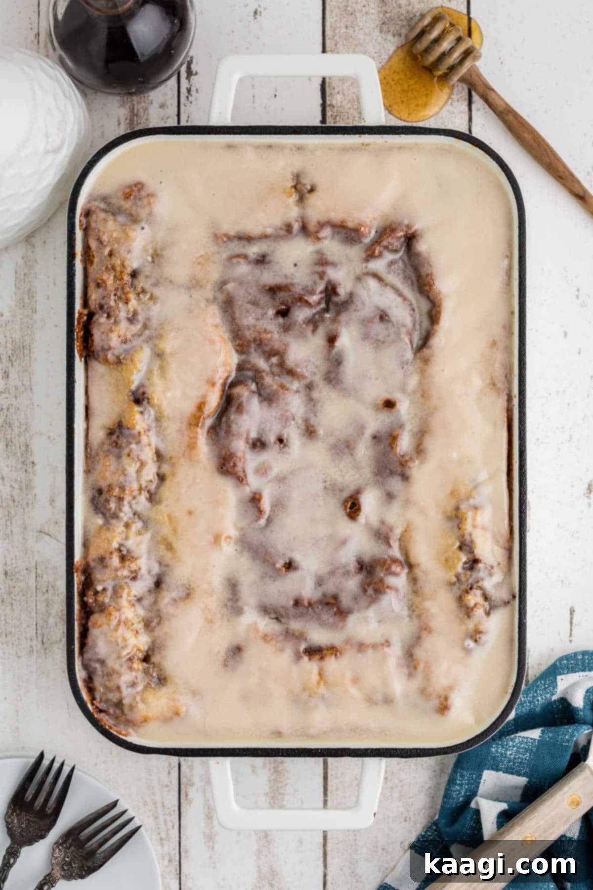 Overhead shot of a full, glazed honey bun cake recipe from scratch, ready to be served.