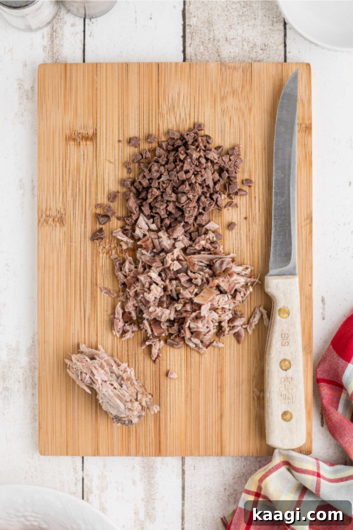 Meat removed from bone and finely diced, on a chopping board, ready to be added to the gravy.