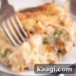 Close up of a chicken cobbler recipe with a fork digging into it.