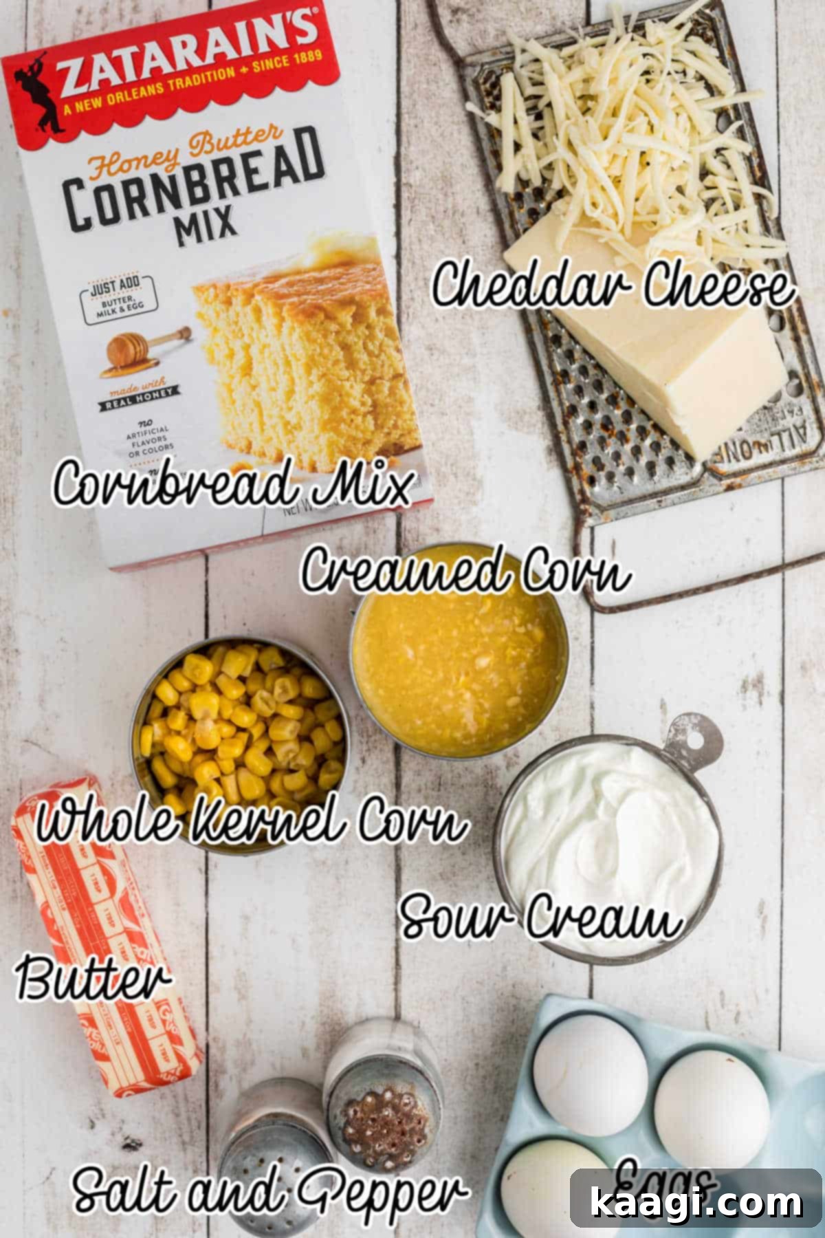 Overhead shot of the ingredients needed to make a cornbread pudding, including eggs, corn, sour cream, butter, and cornbread mix.