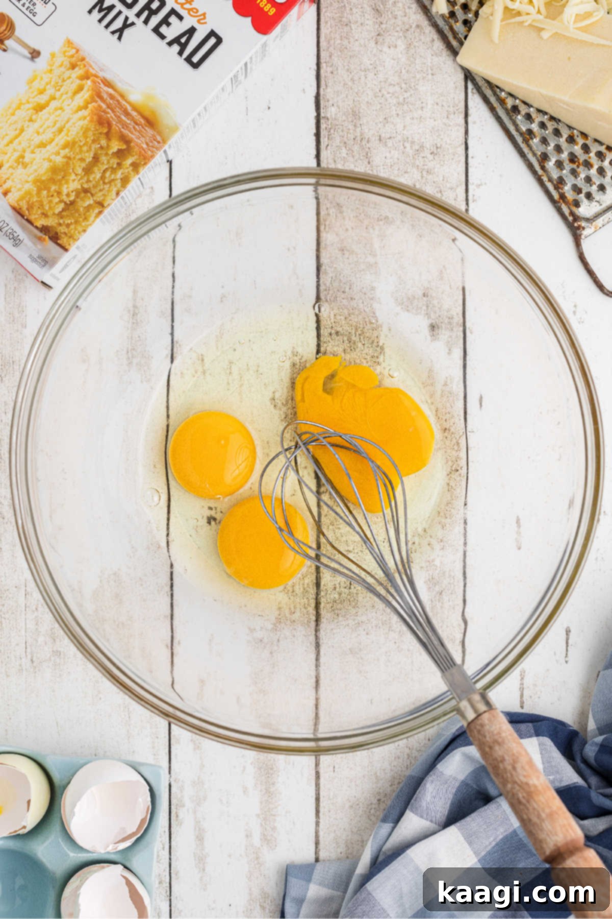 Eggs broken into a mixing bowl, about to be beaten into a smooth consistency.