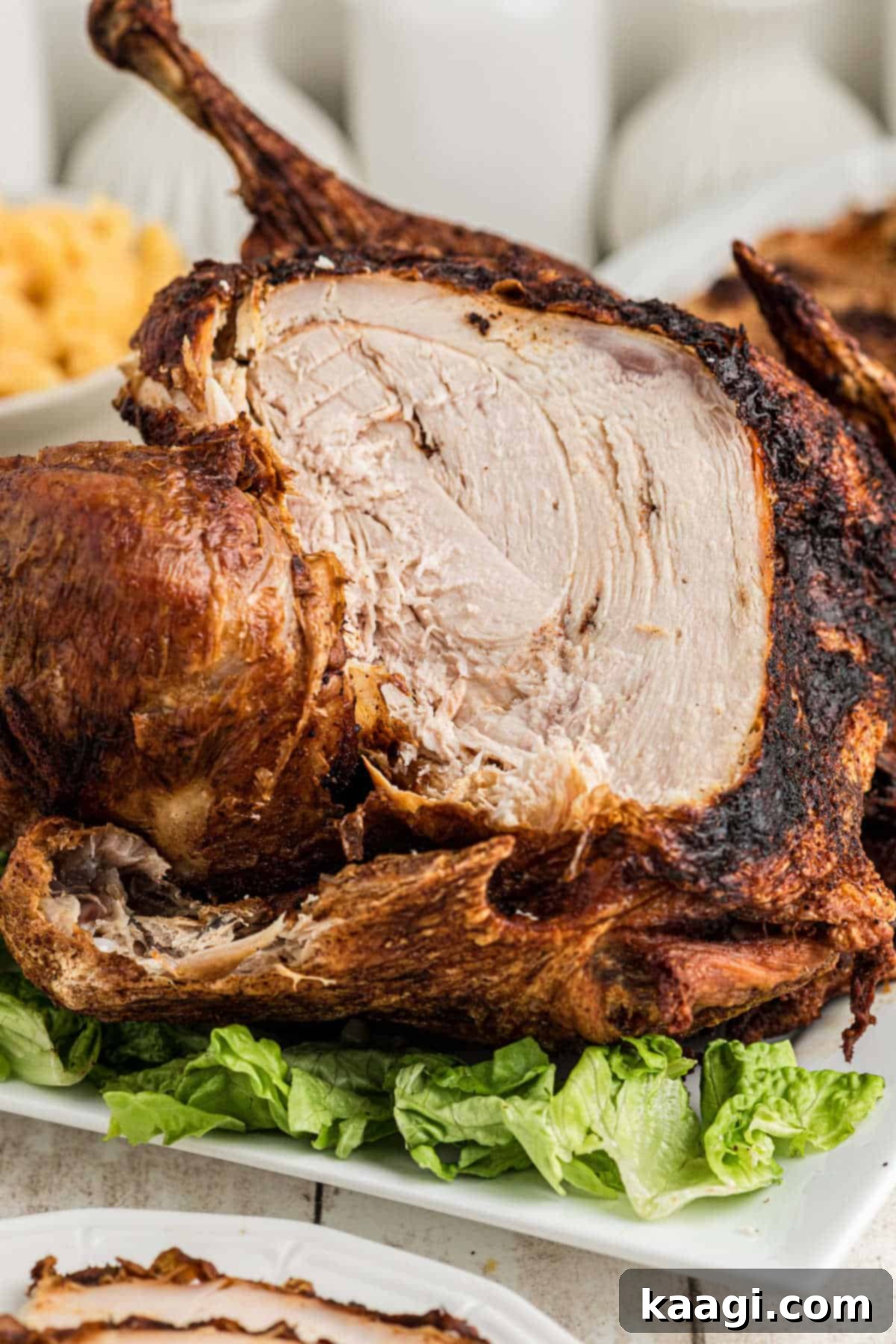 Crisp and Juicy Turkey Triumph 9 A deep fried turkey with several slices removed from the breast, showing juicy white meat.