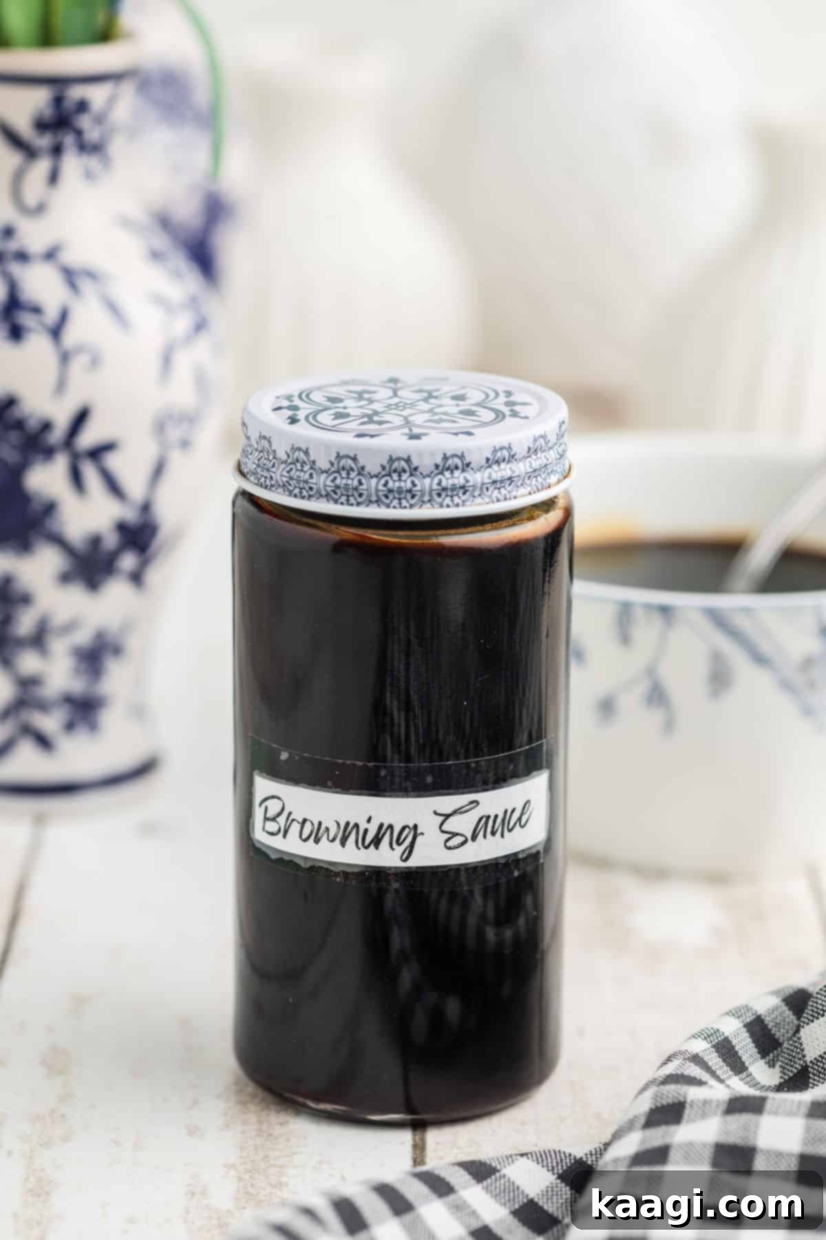 A jar of homemade browning sauce, with a label, sitting proudly on a kitchen counter.