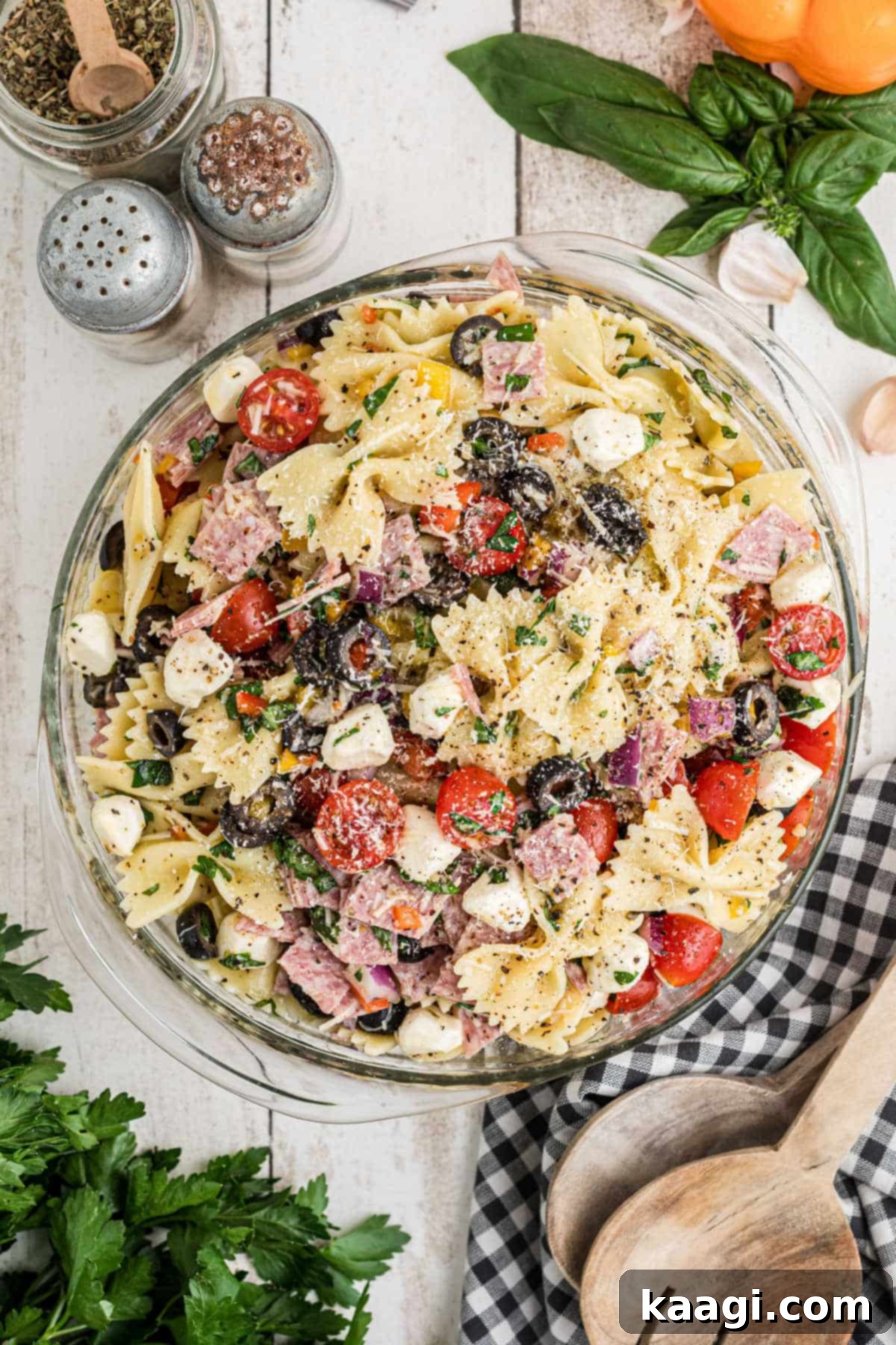 Italian Pasta Perfection 2 An overhead image of a bowl of Italian pasta salad, that has bowtie pasta, olives, feta cheese, tomatoes etc.