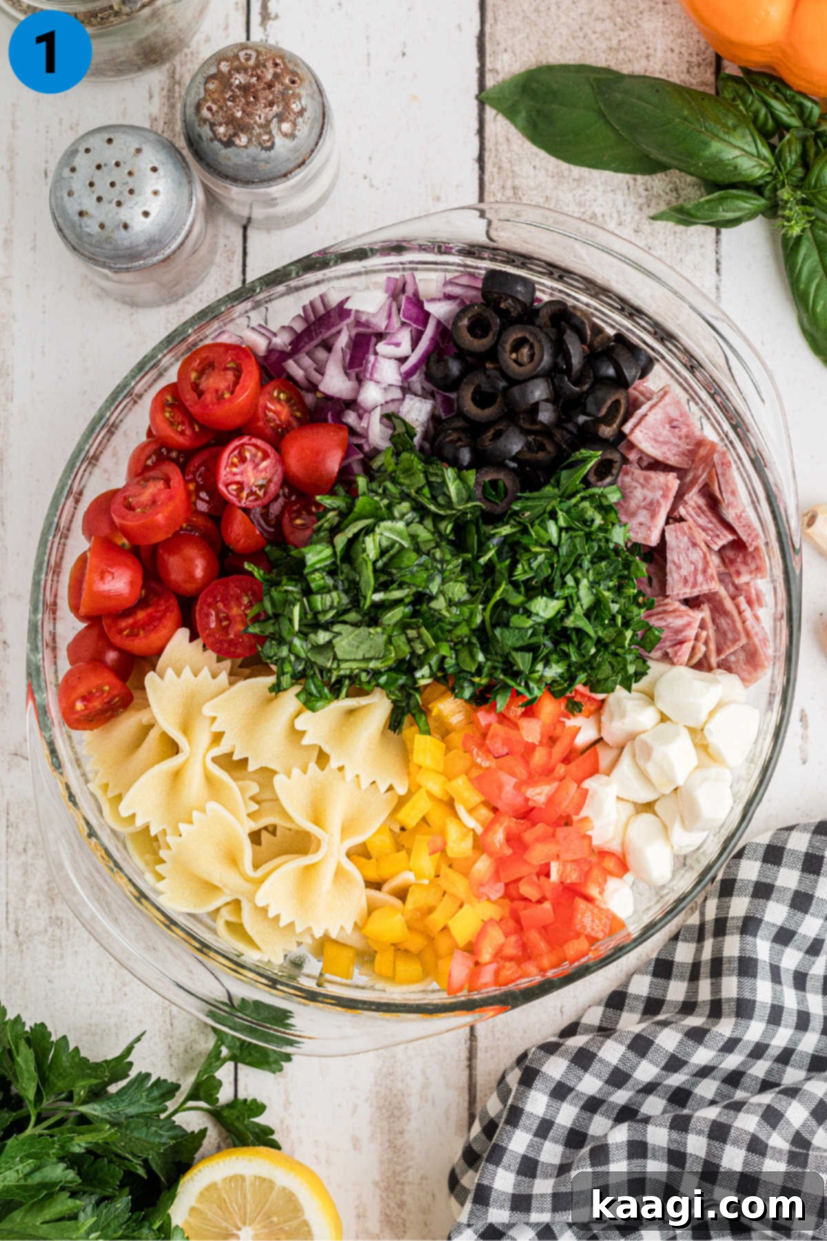 Italian Pasta Perfection 4 A large salad bowl filled with ingredients needed to make an Italian Pasta Salad.