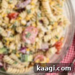 Overhead close up of a bowl of cilantro lime pasta salad, where you can see the rotini pasta.