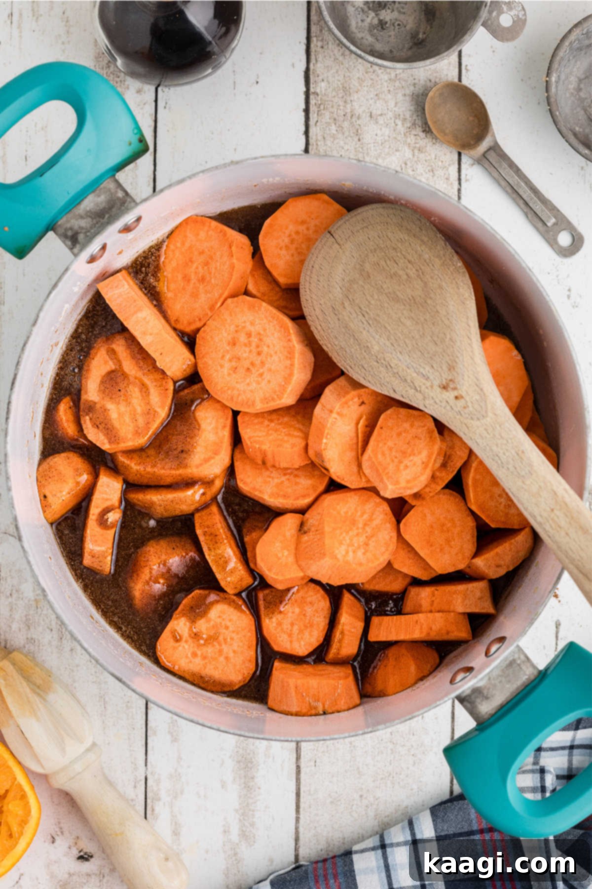 Yam slices being added to a pot with melted butter and sugar.