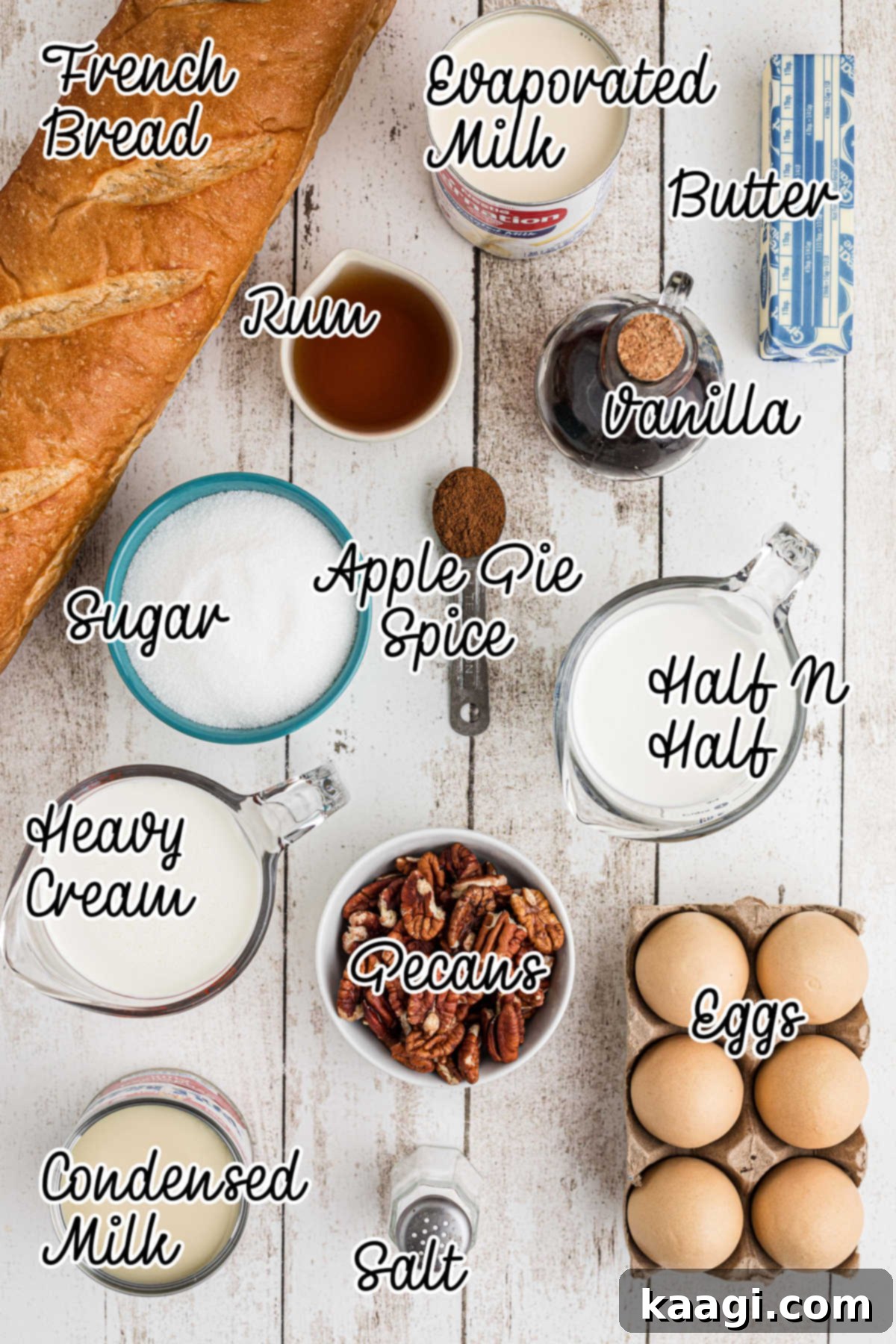 Ingredients needed to make bread pudding with rum sauce, displayed on a wooden surface.