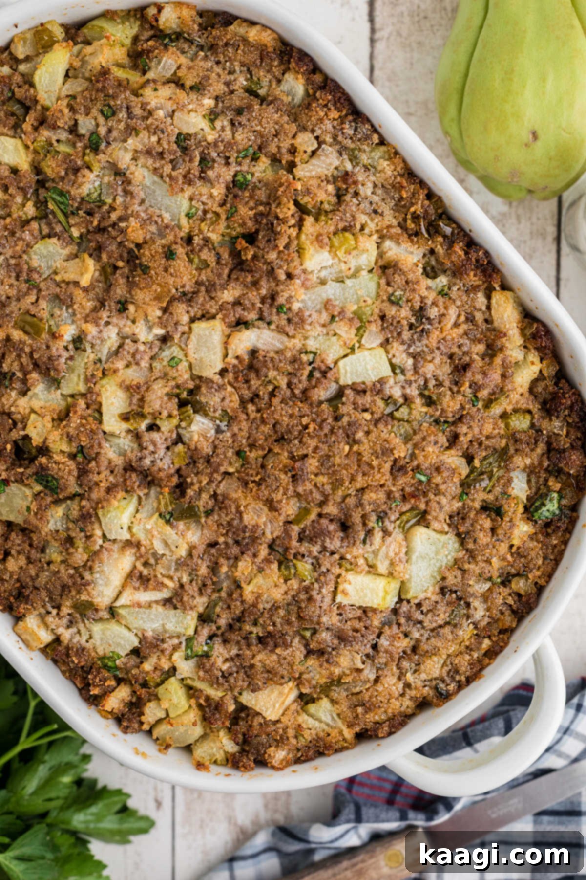 Overhead image of a prepared casserole dish of mirliton stuffing, ready to be served.