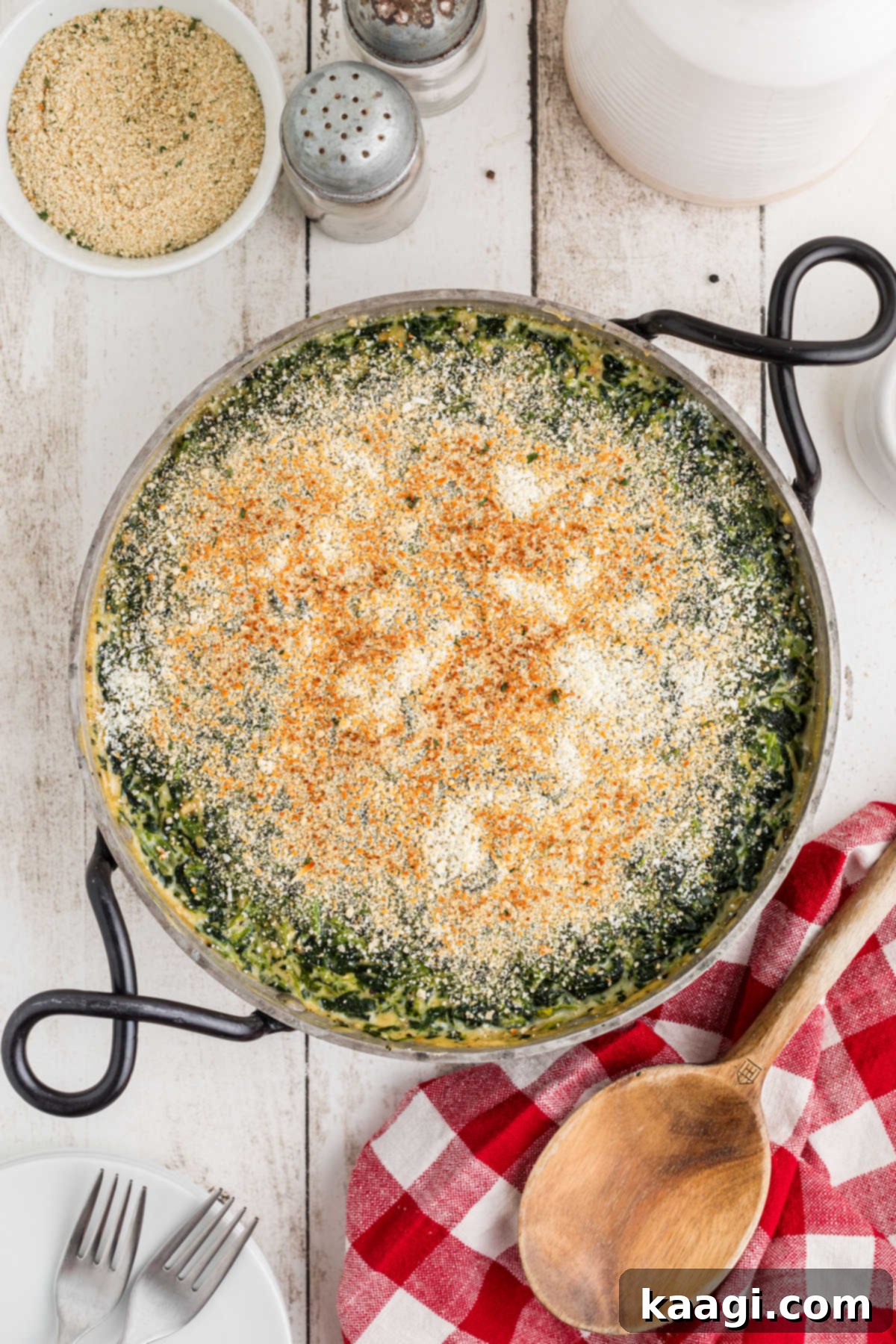 Overhead shot of a spinach madeleine recipe in a decorative pan with cute handles, fresh out of the oven.