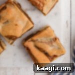 Caramel-Swirled Blondie Squares 7 Overhead close up view of some caramel swirl blondies on a board, perfectly cut and ready to eat.