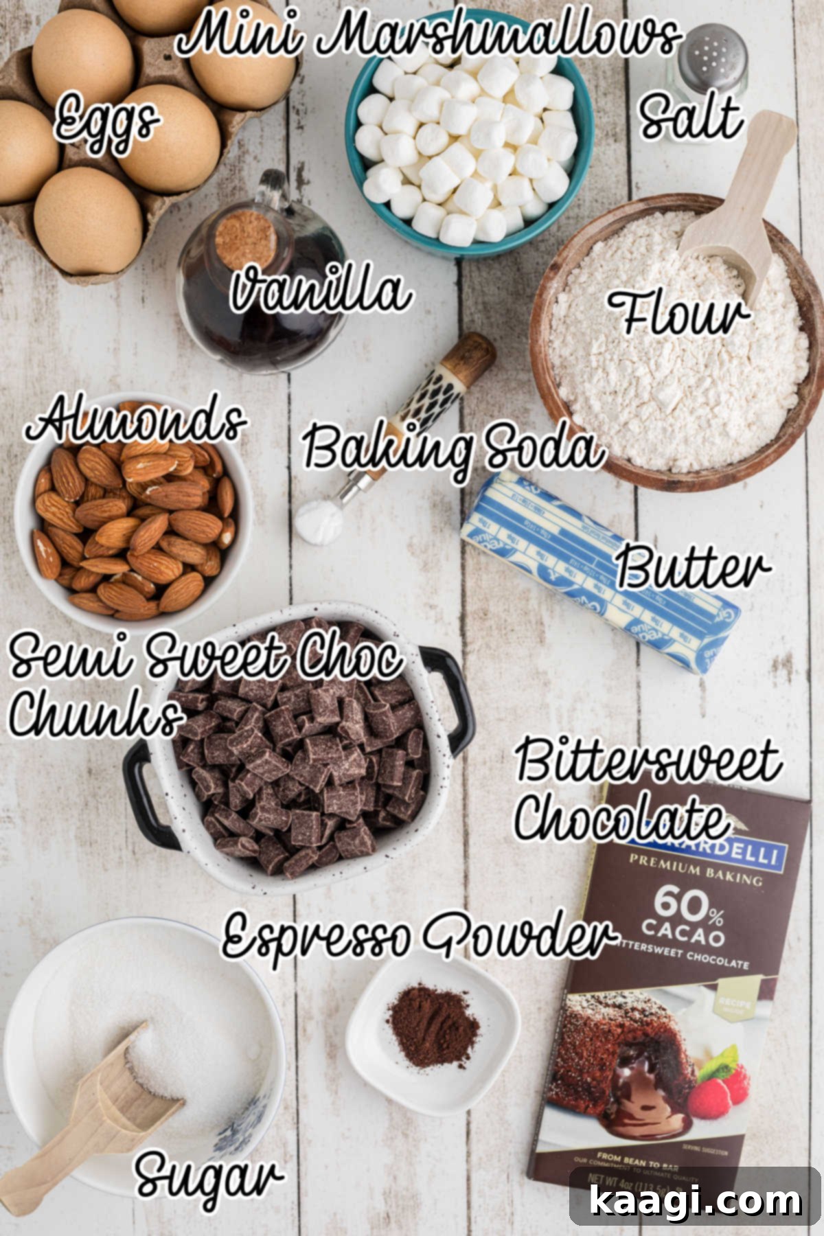 An inviting overhead shot showcasing all the essential ingredients meticulously laid out to make rocky road brownies. Bowls of butter, chocolate, sugar, flour, and a vibrant blue bowl of fluffy marshmallows are neatly arranged on a rustic wooden surface, with a helpful text overlay indicating their purpose.