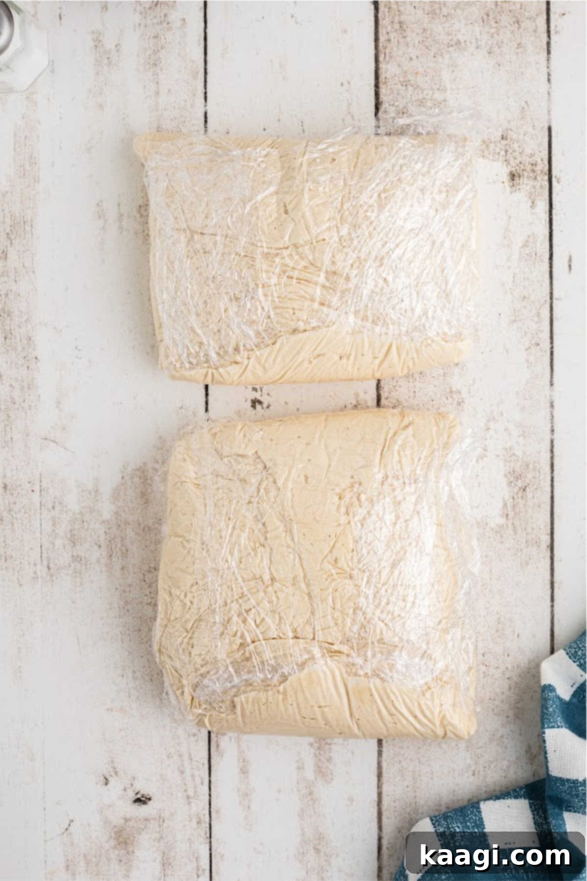 Cookie dough wrapped in plastic wrap, ready for chilling.