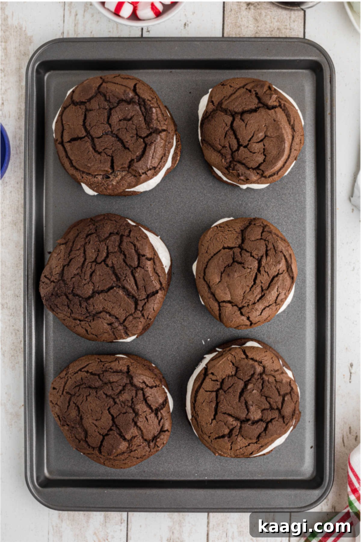 Cookies placed on top of topped cookies, to make a whoopie pie.