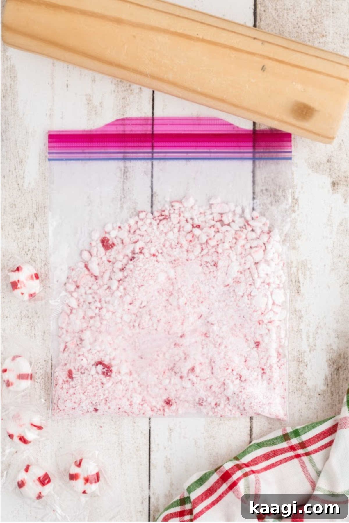 A resealable bag with those Christmas mint candies, being crushed with a rolling pin.