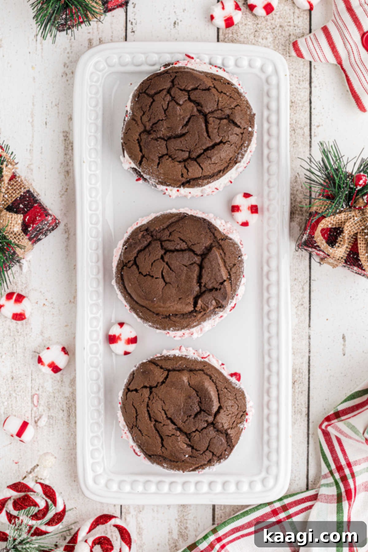 An overhead shot of a plate with 3 Christmas Whoopie Pies on it.