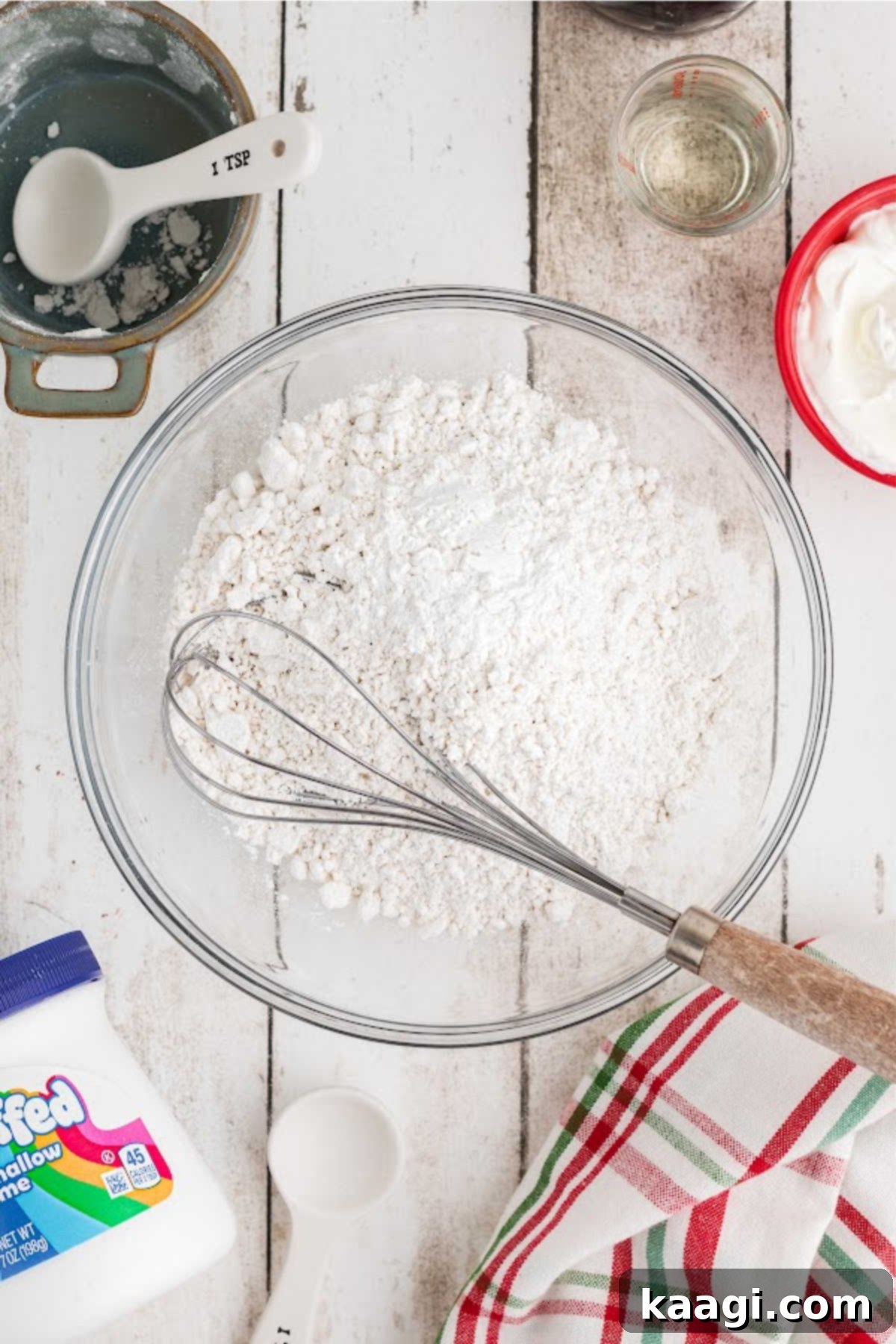 A mixing bowl filled with flour and other ingredients.