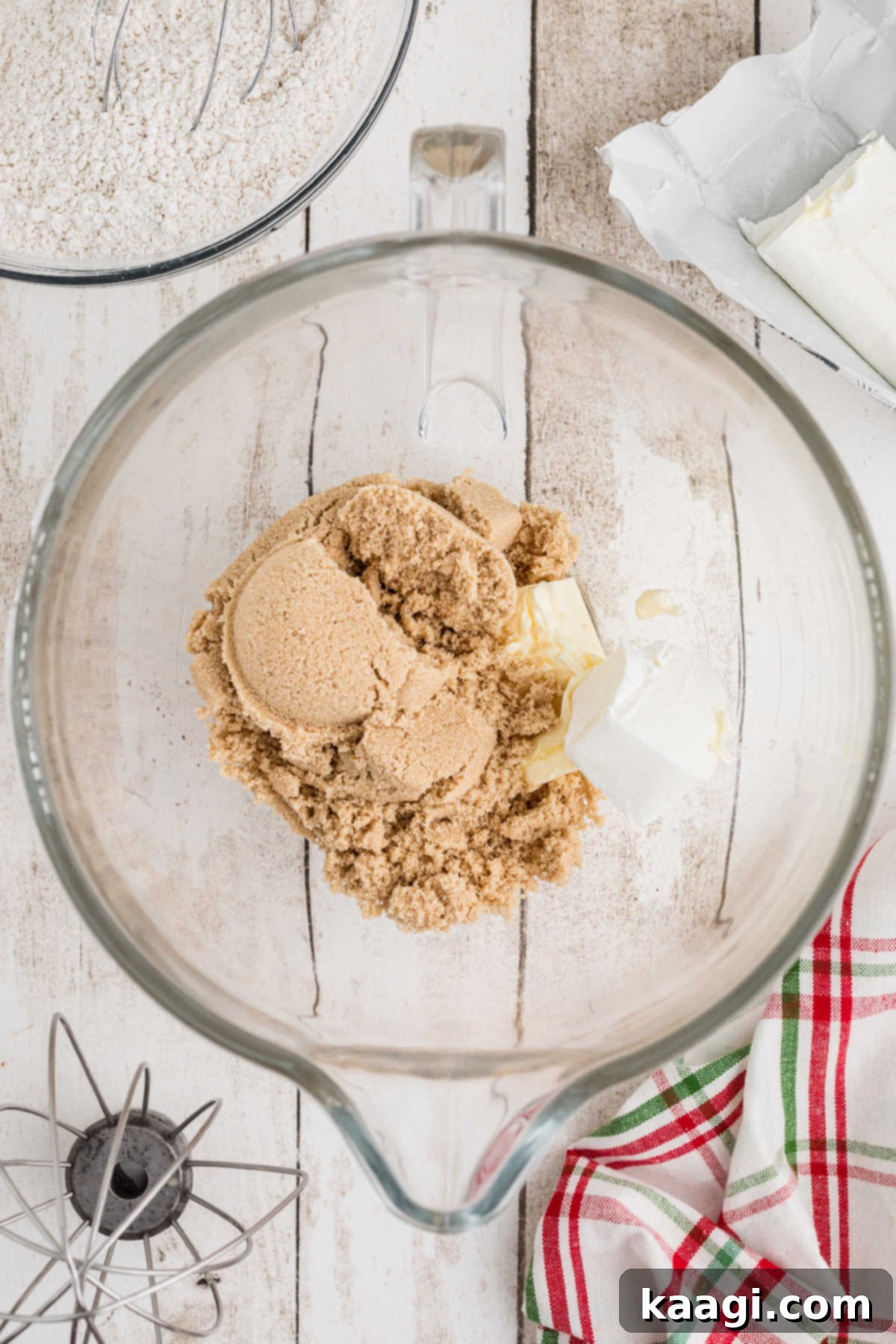Brown sugar added to a mixing bowl with shortening and butter.