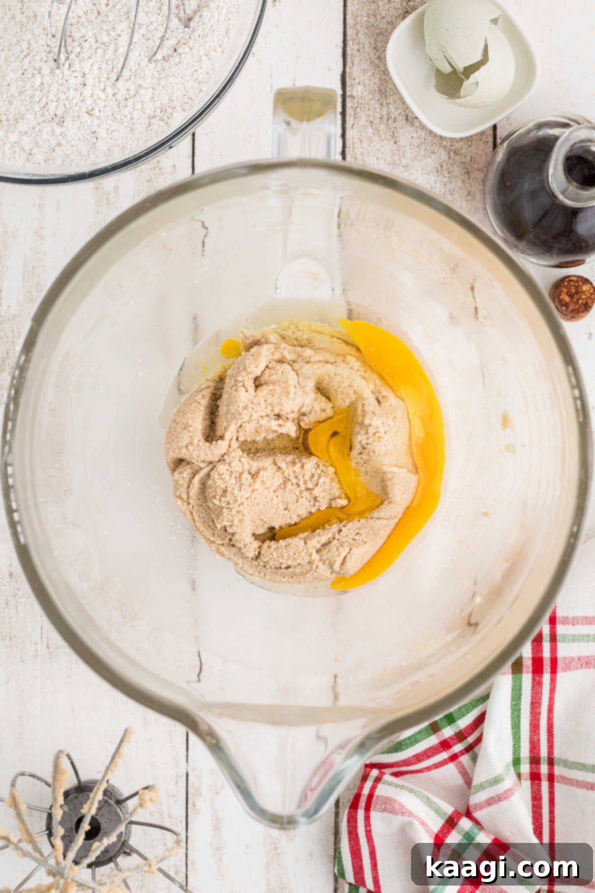 Eggs added to a mixing bowl with sugar etc.