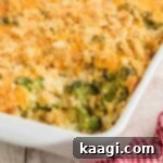 Golden Broccoli Bake 13 Close up of a corner of a baking dish with broccoli casserole, with a scoop missing.