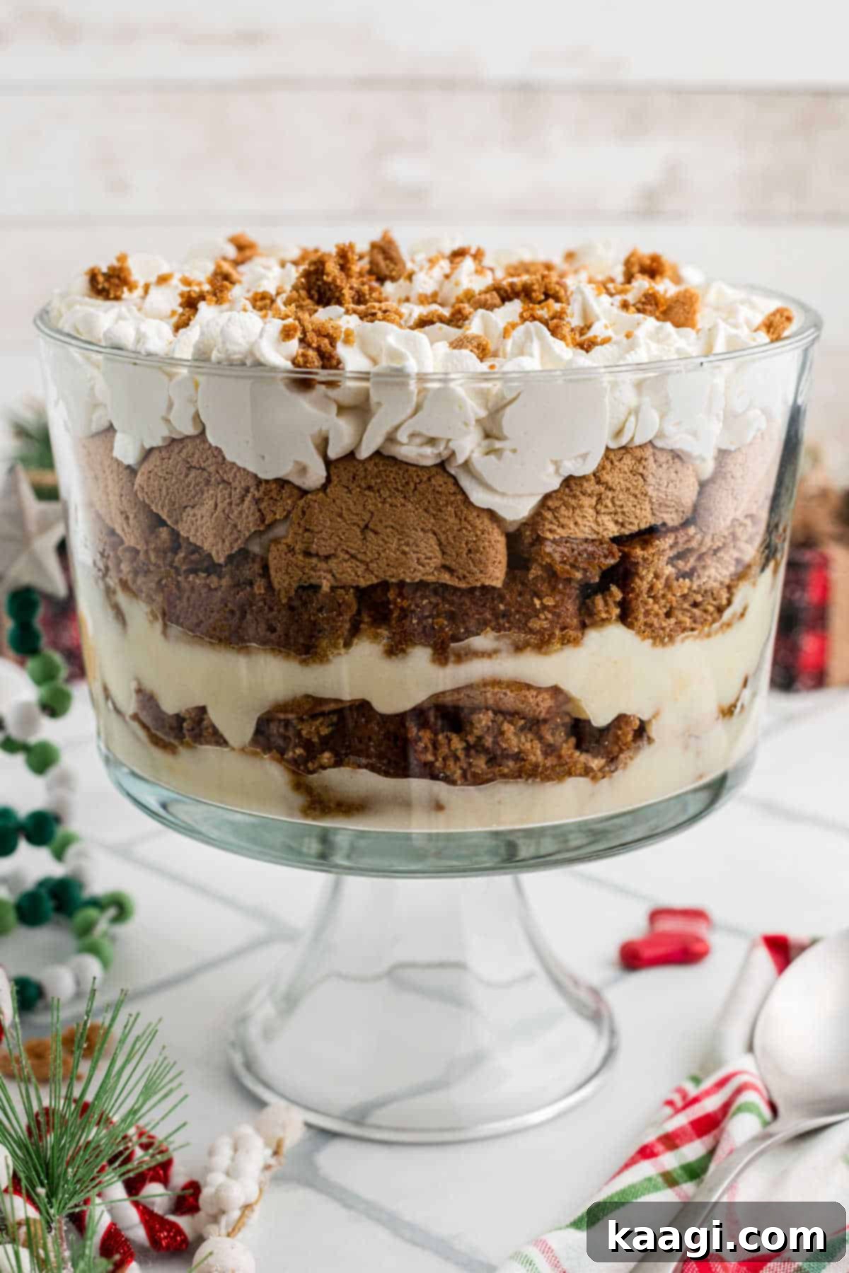 Side shot of a gingerbread trifle, showcasing its beautiful layers of cake, pudding, and cream.