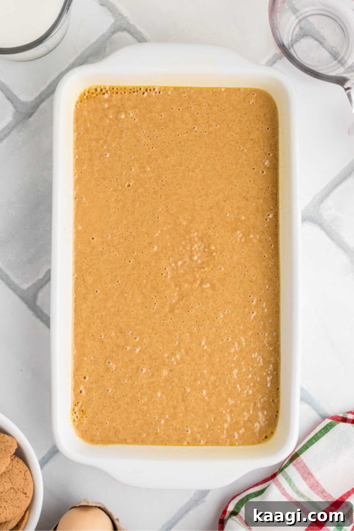 Festive Gingerbread Trifle 5 Gingerbread batter being poured into an 11x7 inch loaf pan.