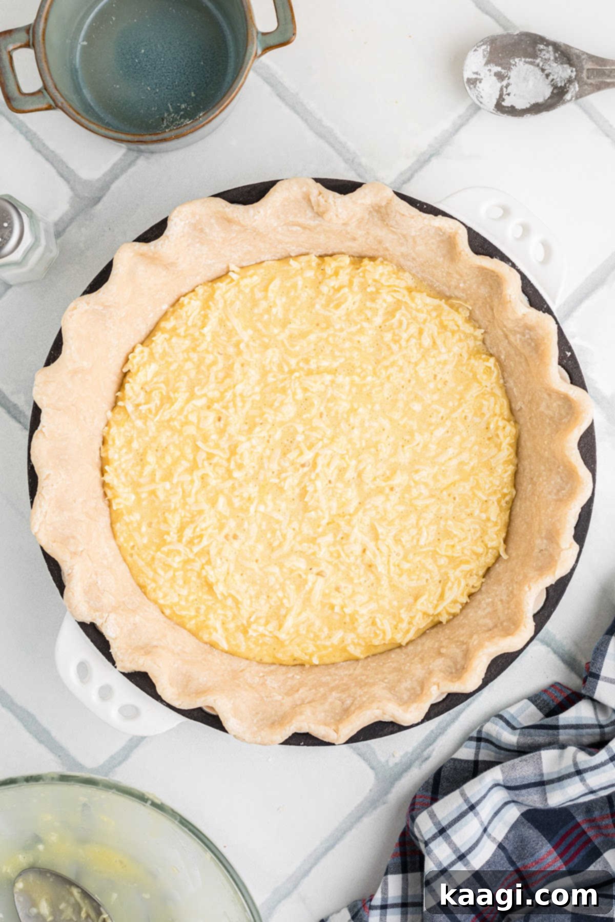 Heirloom Coconut Delight 8 A prepared pie crust generously filled with the creamy coconut pie mixture, ready for baking.