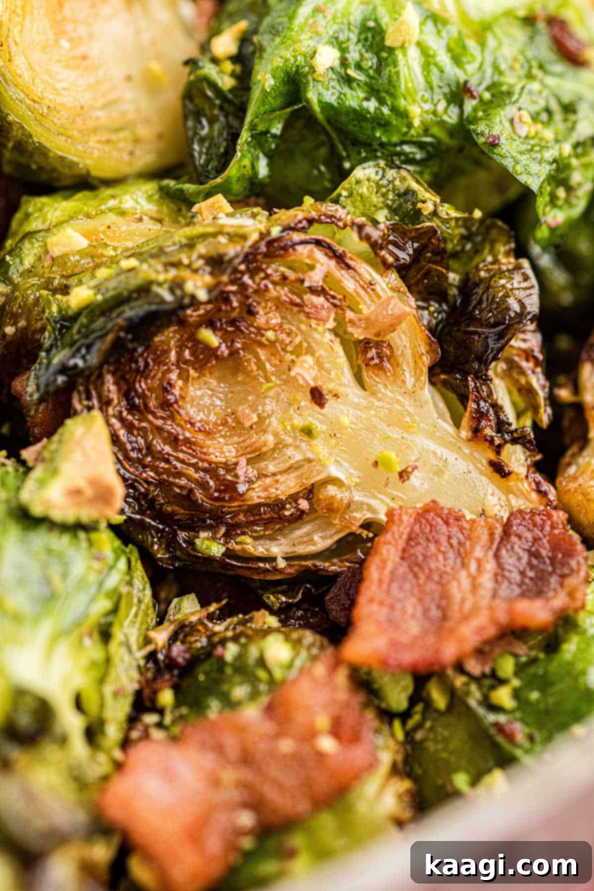 Sweet & Savory Maple Bacon Brussels Sprouts with Crunchy Pistachios 7 Ultra close up shot of a pot with perfectly browned brussel sprouts and crispy bacon bits, ready to be served.