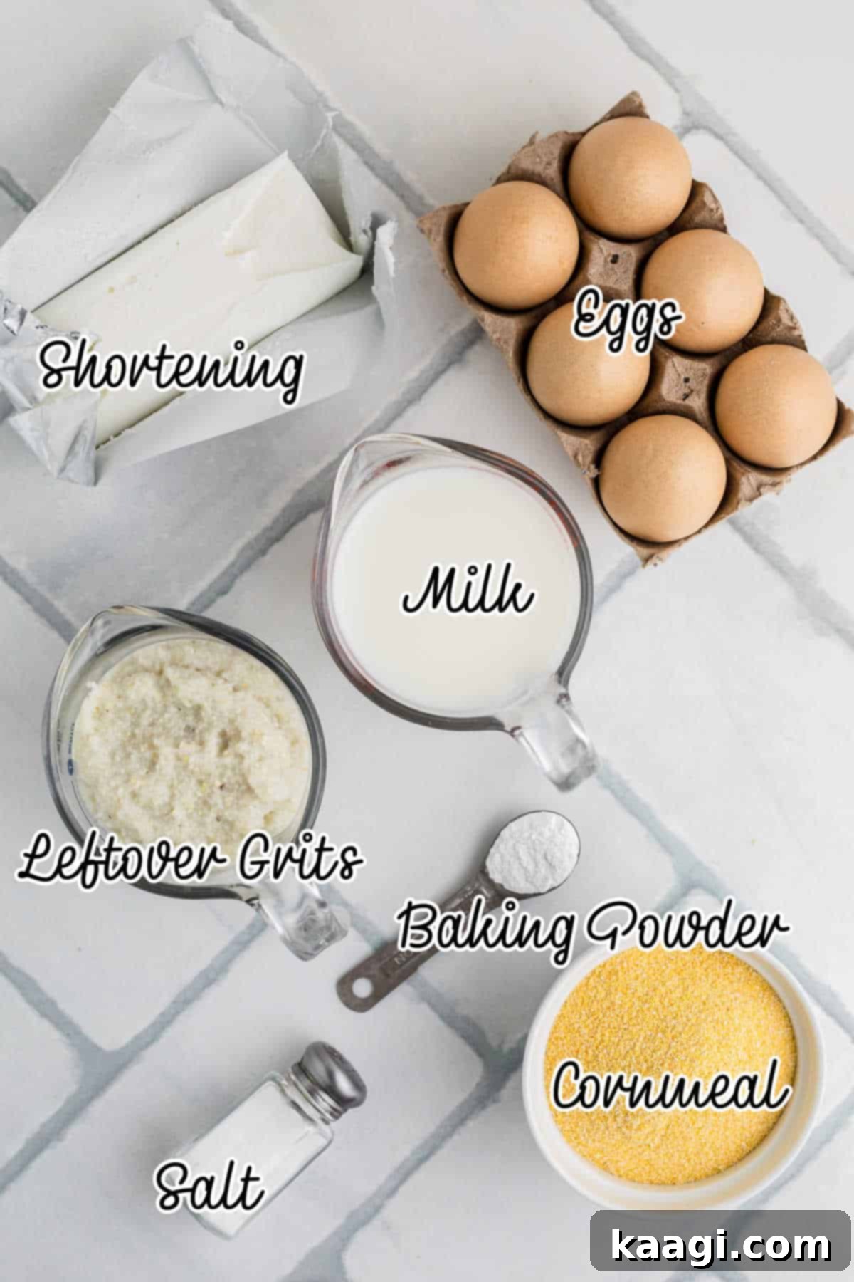 Ingredients needed to make old fashioned southern spoon bread, including cornmeal, grits, milk, eggs, shortening, baking powder, and salt.