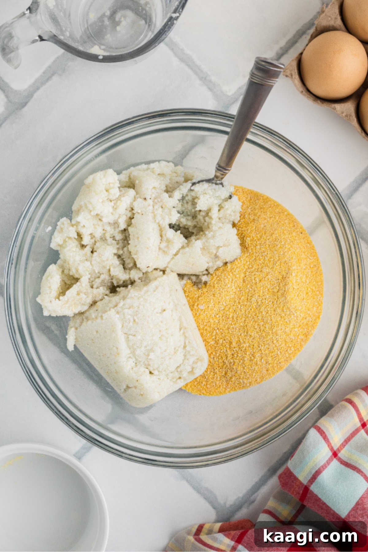 A large mixing bowl with leftover grits and cornmeal, ready to be mashed together.