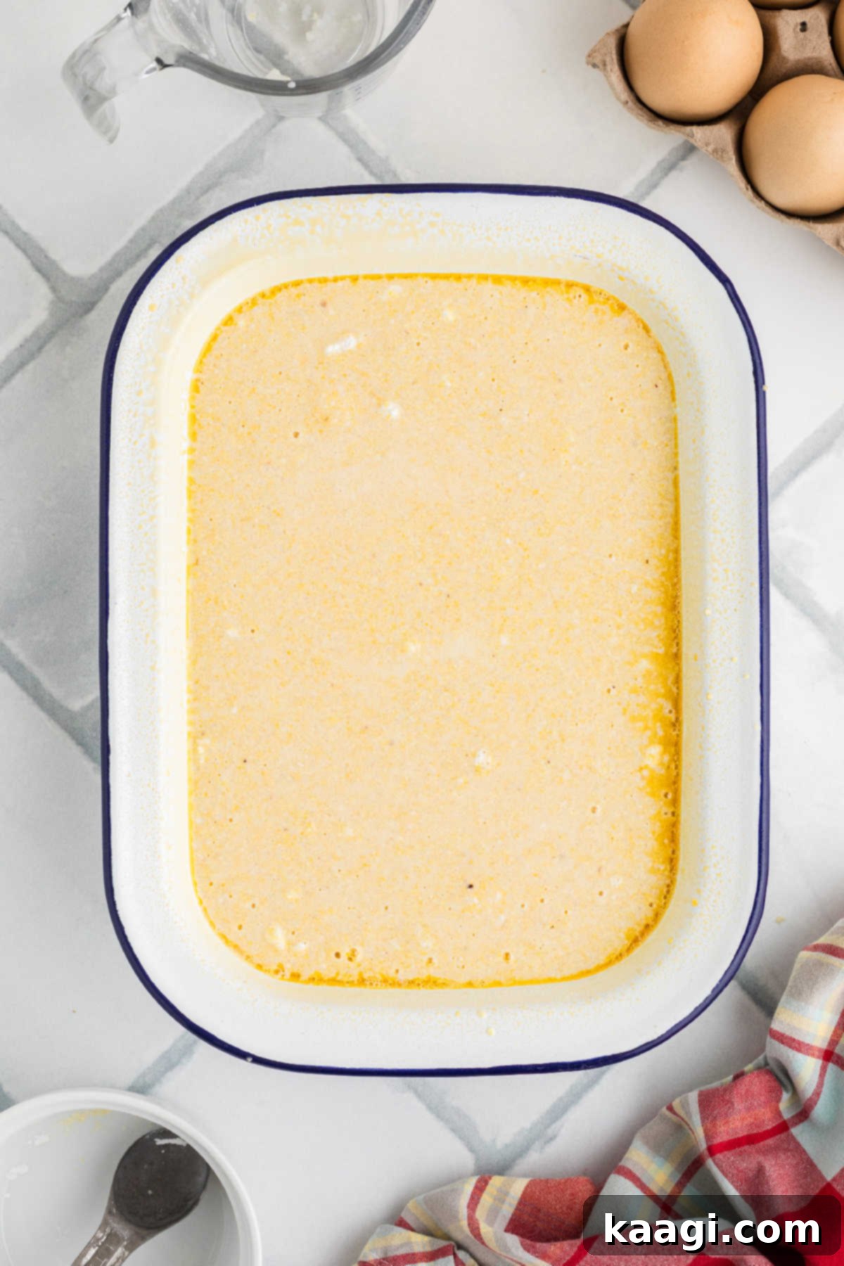 A large baking dish filled with spoon bread batter, ready for the oven.