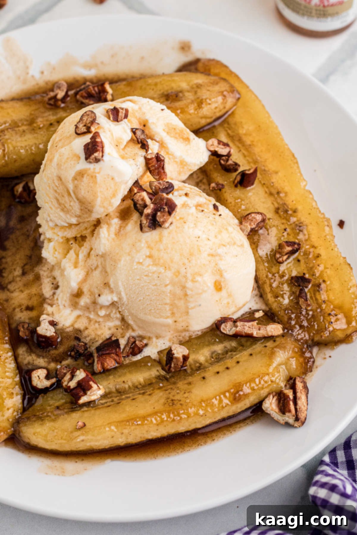 Side angle of a plate of bananas foster with ice cream.