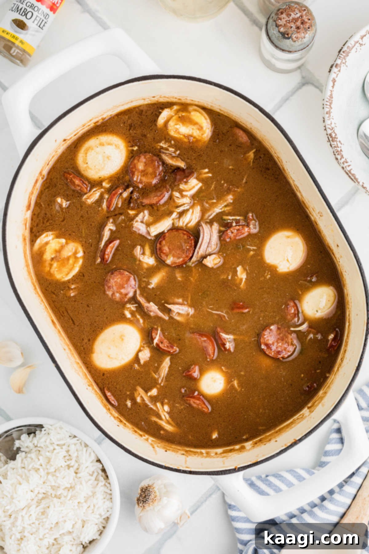 Overhead shot of a large pan filled with Leftover Turkey and Andouille Gumbo, complete with tender turkey, smoky sausage, and halved boiled eggs.
