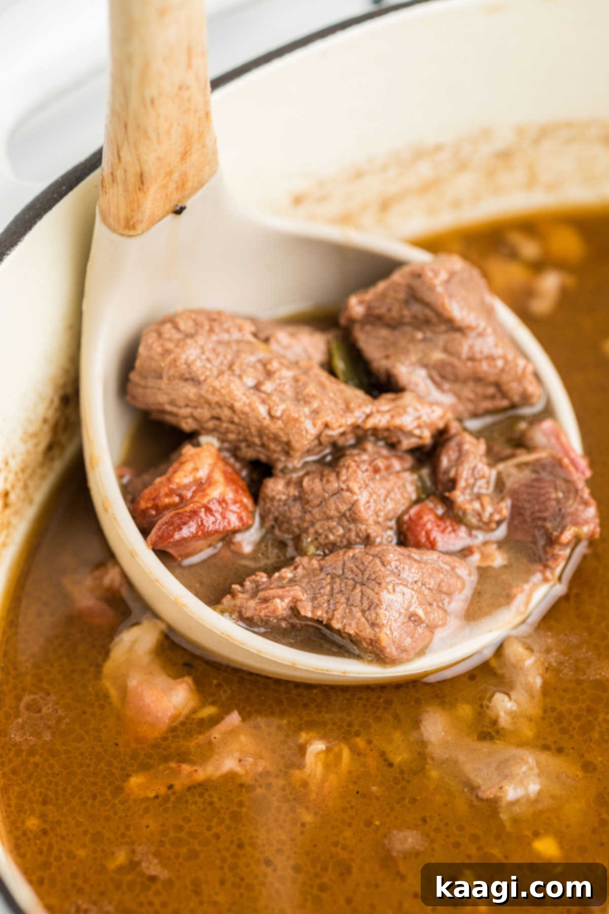 Soulful Southern Beef Gumbo 13 A side shot of a ladle spooning out some beef gumbo from a pot.