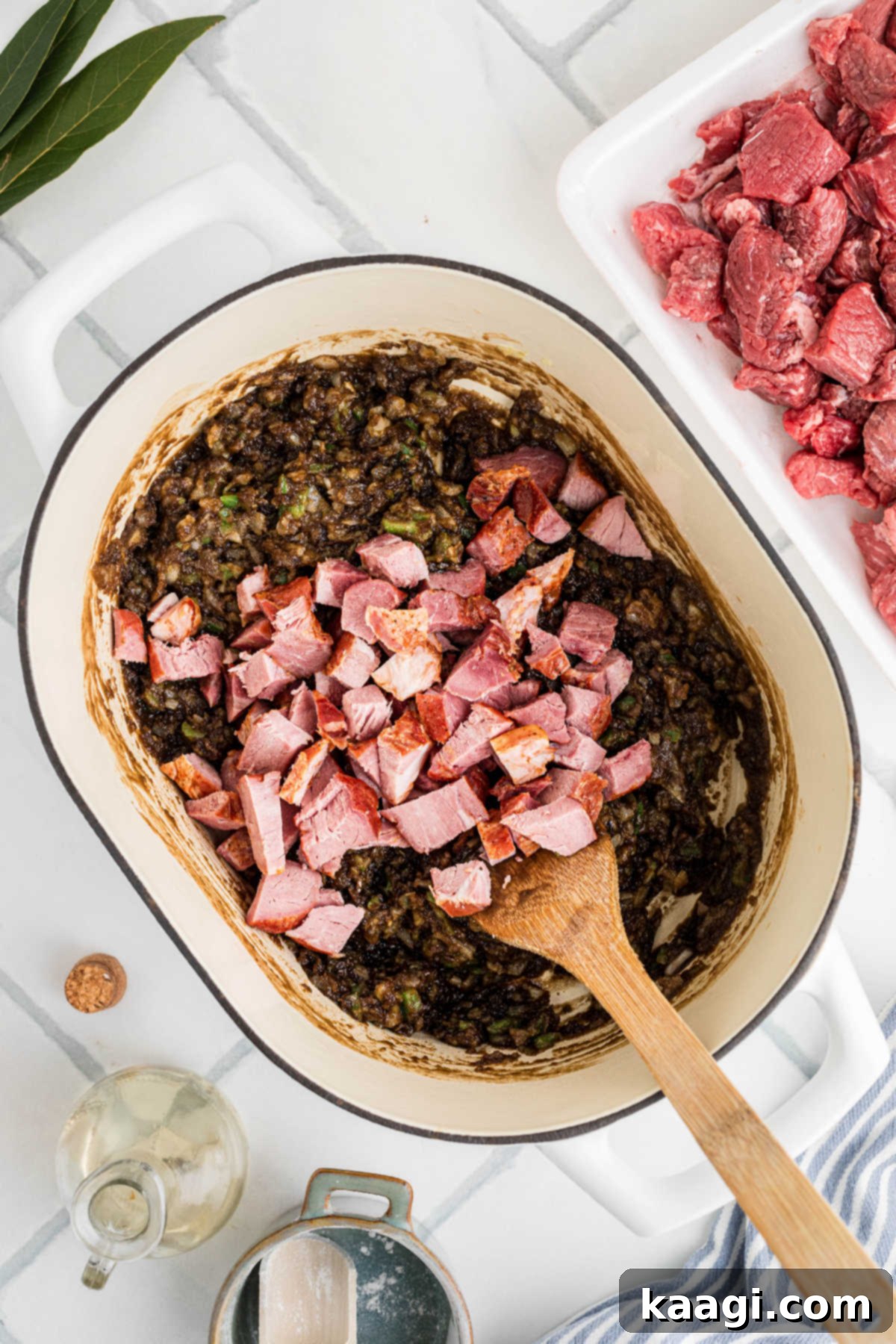 Soulful Southern Beef Gumbo 7 Sliced sausages being added to a large pot with other ingredients.